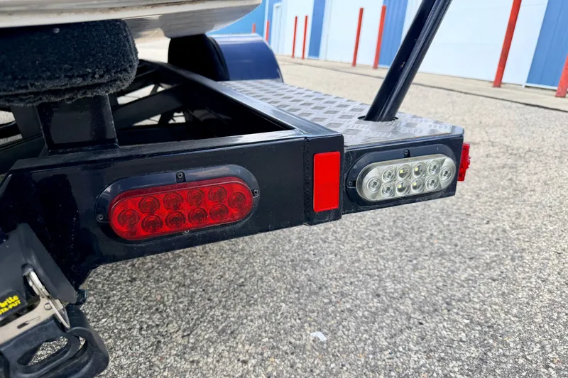 Slide: The Image of Trailer lights on a 2014 Nautique Super Air Nautique 210, parked on asphalt. - 106