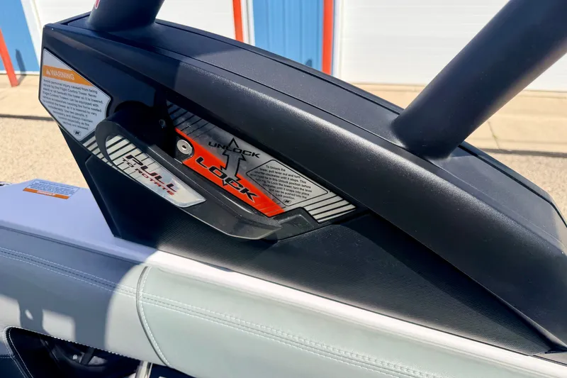 Slide: The Image of Close-up of 2014 Nautique Super Air Nautique 210 boat's locking mechanism and warning label. - 90