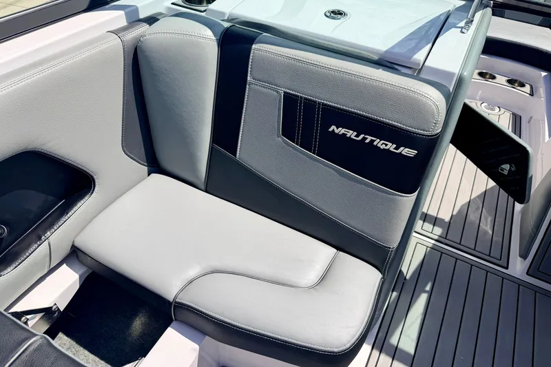 Slide: The Image of 2014 Nautique Super Air Nautique 210 interior seating with branded upholstery. - 47