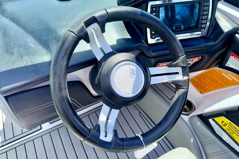 Slide: The Image of Steering wheel and dashboard of 2014 Nautique Super Air Nautique 210 boat. - 52