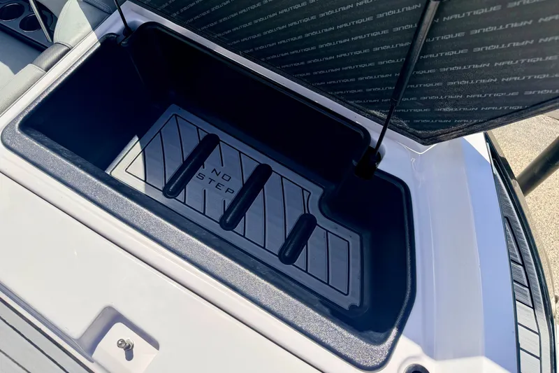 Slide: The Image of 2014 Nautique Super Air Nautique 210 storage compartment with "No Step" warning. - 24