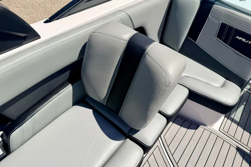 Slide: The Image of 2014 Nautique Super Air Nautique 210 interior seating with gray upholstery and sleek design. - 43
