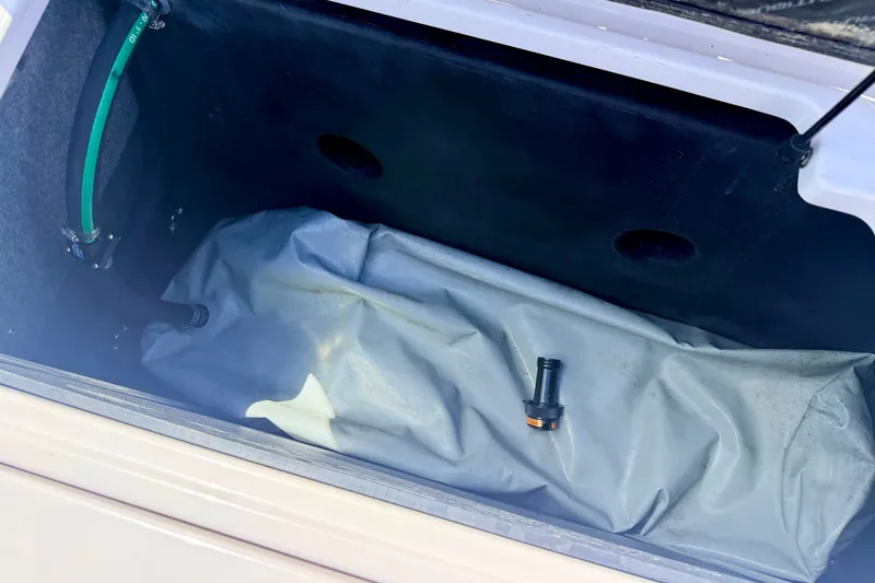 Slide: The Image of 2014 Nautique Super Air Nautique 210 ballast compartment with hoses and fittings. - 25