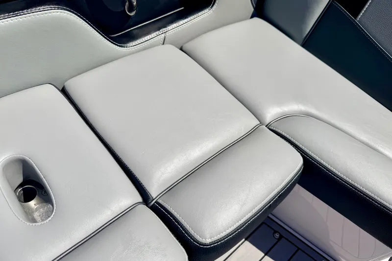 Slide: The Image of 2014 Nautique Super Air Nautique 210 boat seating with cup holder, gray upholstery. - 45