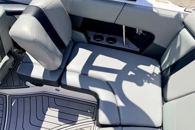 Slide: The Image of 2014 Nautique Super Air Nautique 210 interior seating with cup holders and sleek design. - 35