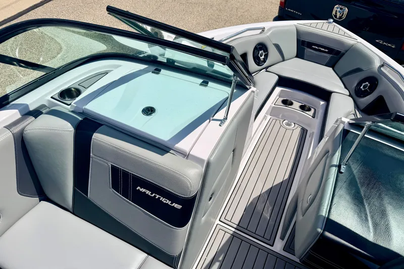 Slide: The Image of 2014 Nautique Super Air Nautique 210 boat interior with sleek seating and modern design. - 84