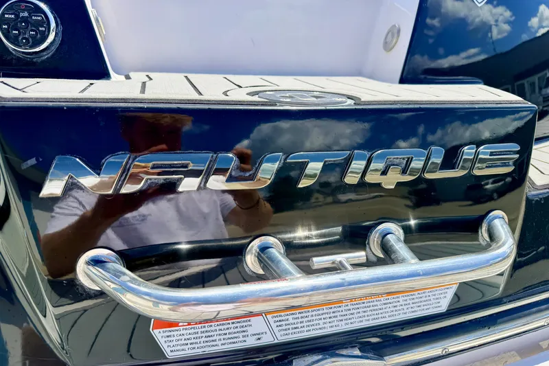Slide: The Image of Close-up of 2014 Nautique Super Air Nautique 210 boat logo and chrome details. - 19