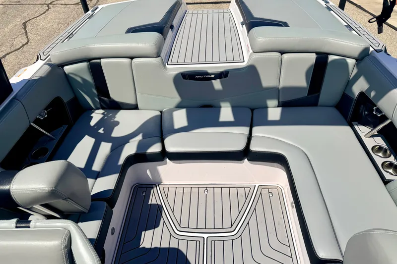 Slide: The Image of 2014 Nautique Super Air Nautique 210 interior with gray seating and deck. - 34