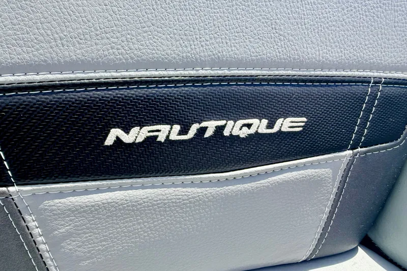 Slide: The Image of 2014 Nautique Super Air Nautique 210 boat seat with logo detail. - 76