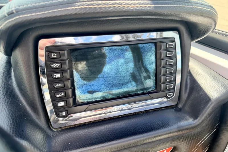 Slide: The Image of 2014 Nautique Super Air Nautique 210 dashboard display with control buttons. - 53