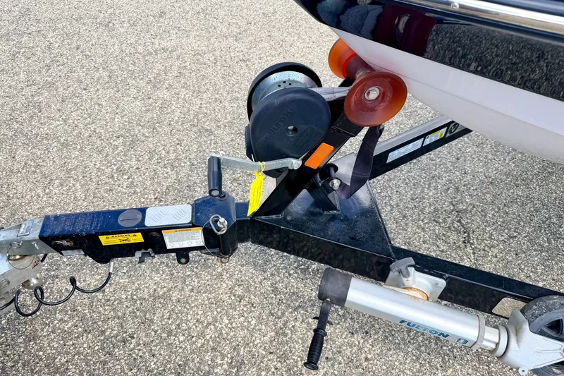 Slide: The Image of Trailer hitch of 2014 Nautique Super Air Nautique 210 boat on pavement. - 101