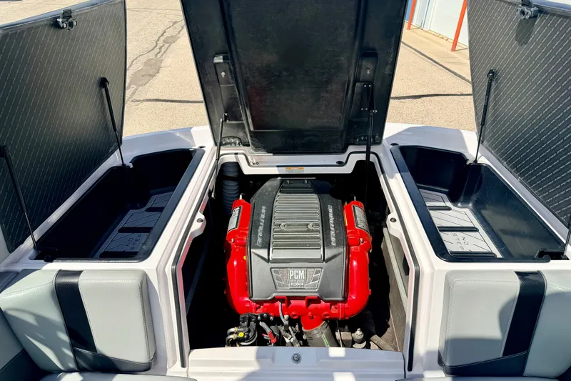 Slide: The Image of 2014 Nautique Super Air Nautique 210 engine compartment with open storage hatches. - 32