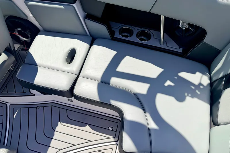 Slide: The Image of Interior seating of 2014 Nautique Super Air Nautique 210 boat with cup holders. - 36