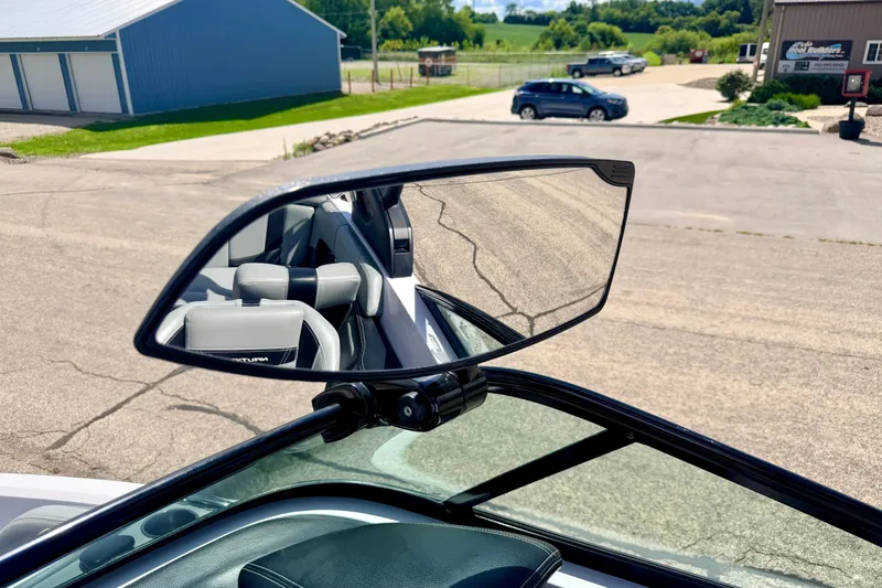 Slide: The Image of 2014 Nautique Super Air Nautique 210 rearview mirror reflecting interior seats. - 51