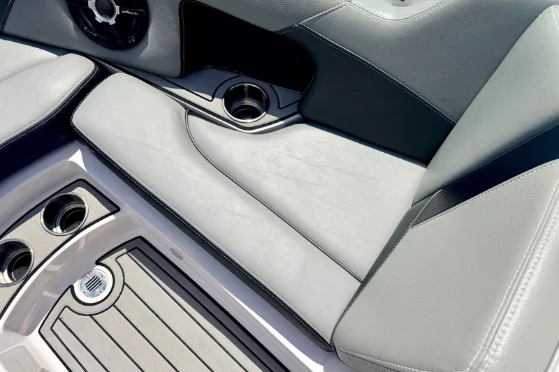 Slide: The Image of Interior seating of a 2014 Nautique Super Air Nautique 210 boat with cup holders. - 72