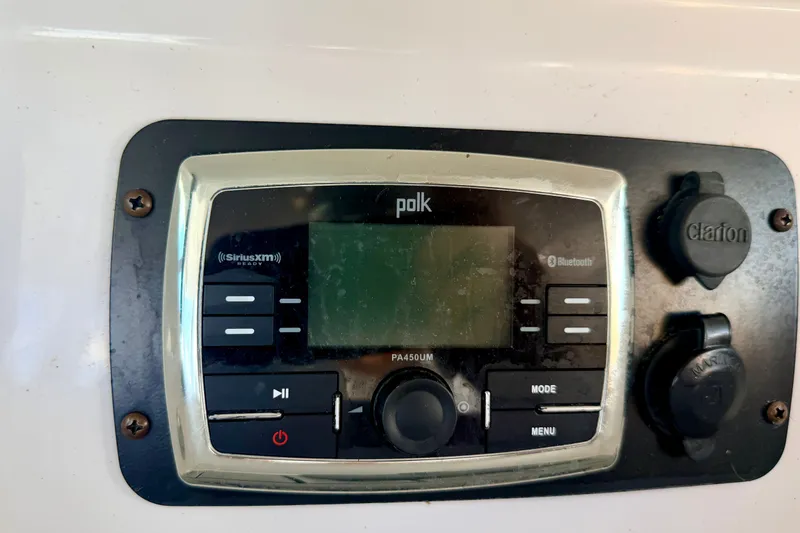 Slide: The Image of Polk marine audio system on 2014 Nautique Super Air Nautique 210 boat dashboard. - 62