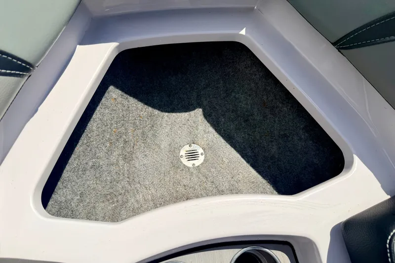 Slide: The Image of Interior view of a 2014 Nautique Super Air Nautique 210 boat, featuring carpeted flooring. - 71