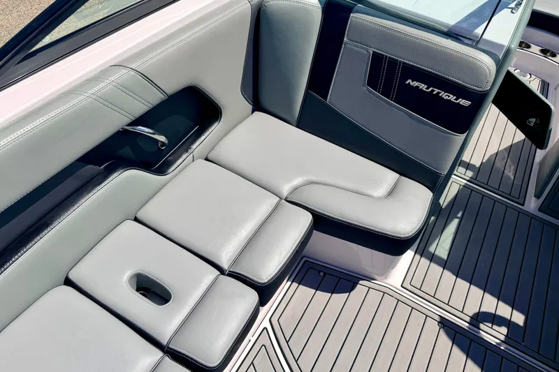 Slide: The Image of 2014 Nautique Super Air Nautique 210 interior seating with sleek gray upholstery. - 44