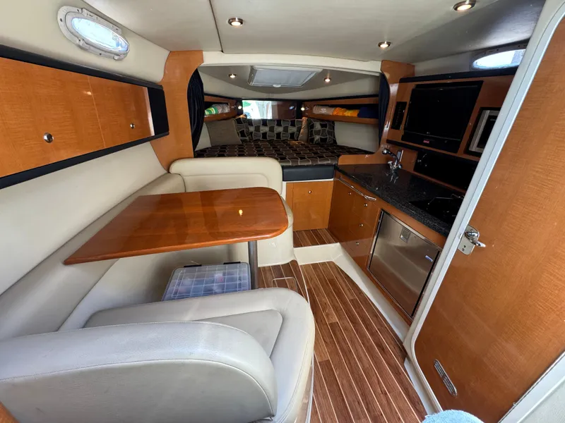 Slide: The Image of Interior of 2011 Chaparral 290 Signature with kitchen and seating area. - 13