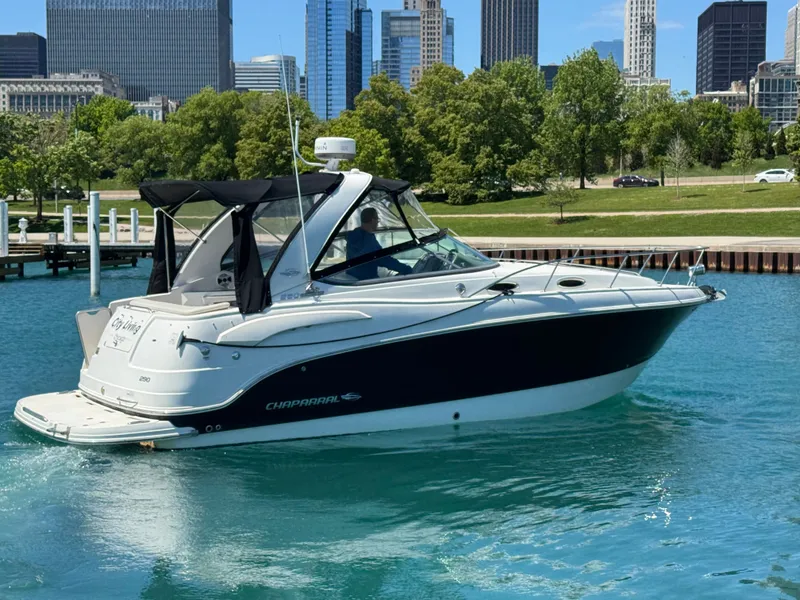 Slide: The Image of 2011 Chaparral 290 Signature boat on blue water with city skyline. - 24