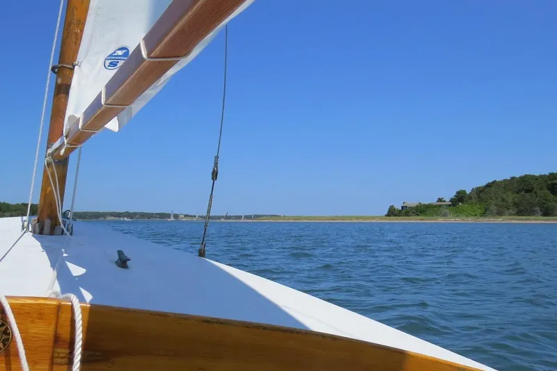 Slide: The Image of Sailing on a 1997 COMPASS CLASSIC Catboat in clear blue waters under a sunny sky. - 10