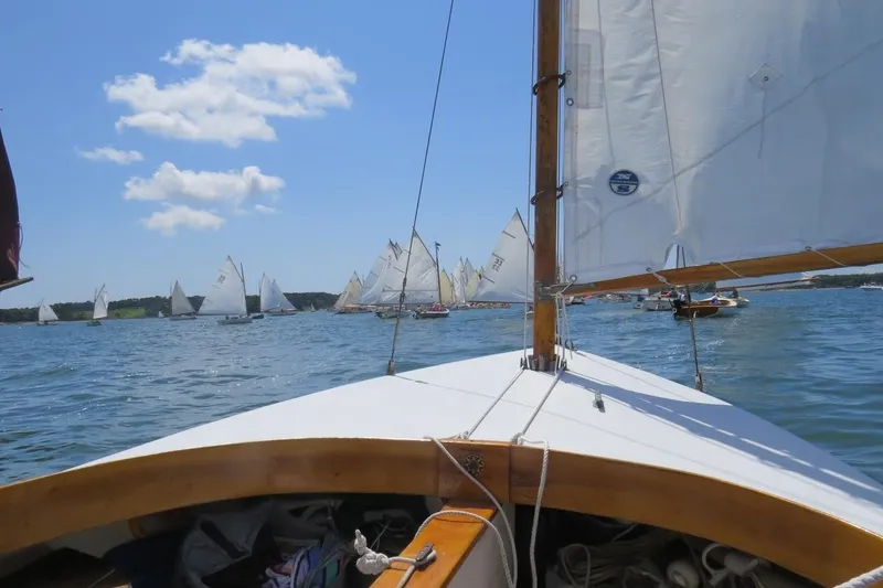 Slide: The Image of Sailing on a 1997 COMPASS CLASSIC Catboat during a regatta under a clear blue sky. - 12