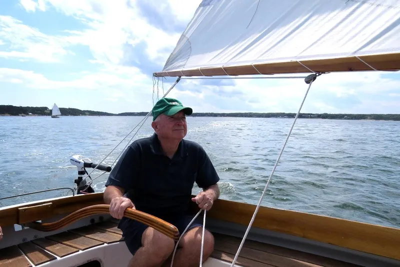 Slide: The Image of Man sailing a 1997 COMPASS CLASSIC Catboat on a sunny day. - 2