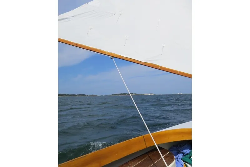 Slide: The Image of Sailing on a 1997 COMPASS CLASSIC Catboat, ocean view with clear skies. - 8