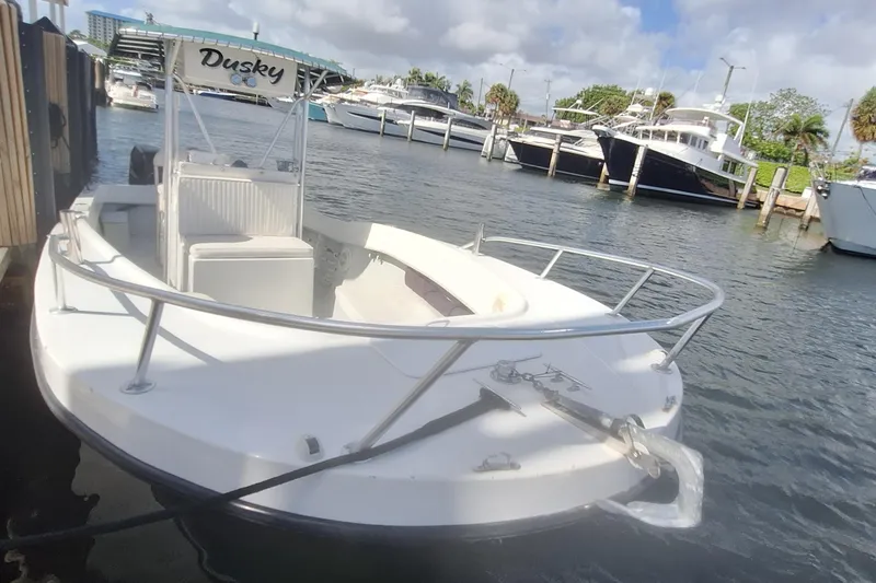 The Image of 2001 Dusky 252 Open Fisherman boat docked with twin Suzuki engines. - 0