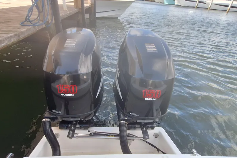 Slide: The Image of Twin Suzuki 150 outboard motors on a 2001 Dusky 252 Open Fisherman boat. - 3