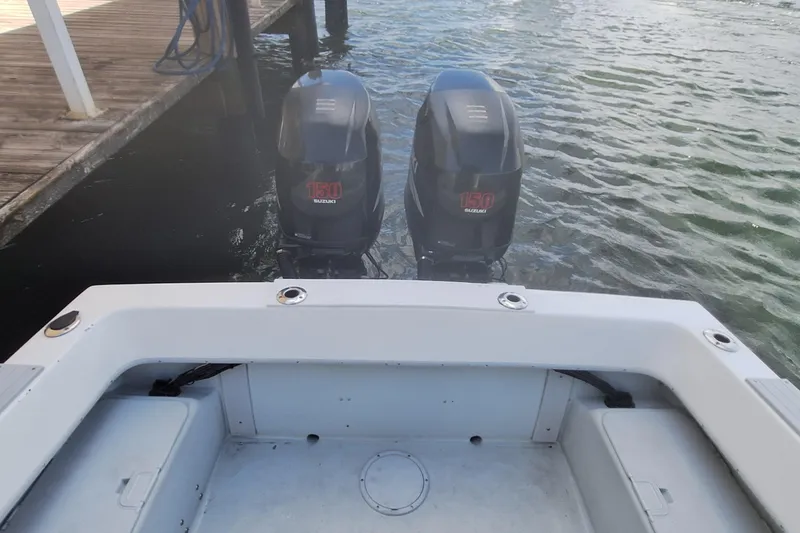 Slide: The Image of Dusky 252 Open Fisherman 2001 with twin Suzuki 150 engines at dock. - 4