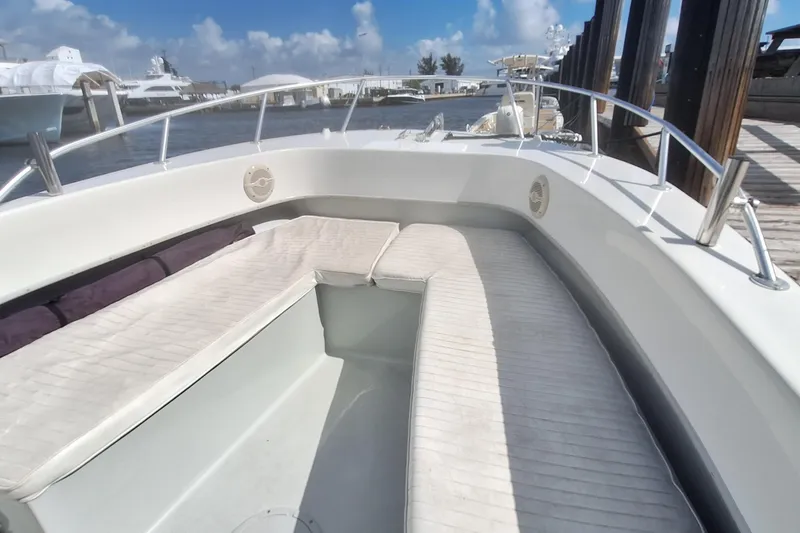 Slide: The Image of Dusky 252 Open Fisherman 2001 with cushioned seating at the dock. - 8
