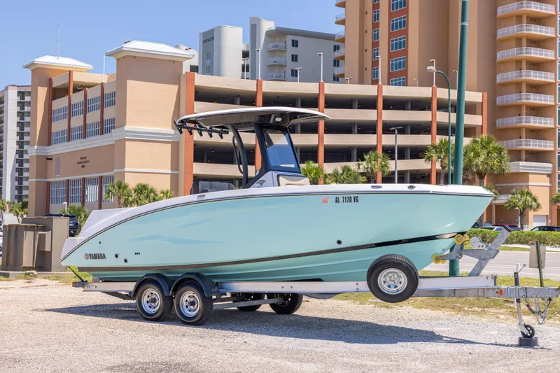 The Image of 2025 Yamaha Boats 255 FSH Sport E on trailer, urban background. - 0