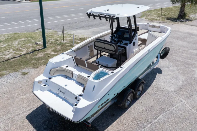 Slide: The Image of 2025 Yamaha Boats 255 FSH Sport E on trailer, showcasing sleek design and spacious interior. - 13
