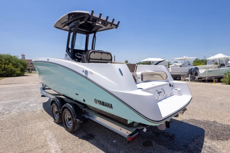 Slide: The Image of 2025 Yamaha Boats 255 FSH Sport E on trailer, sleek design, sunny day. - 14