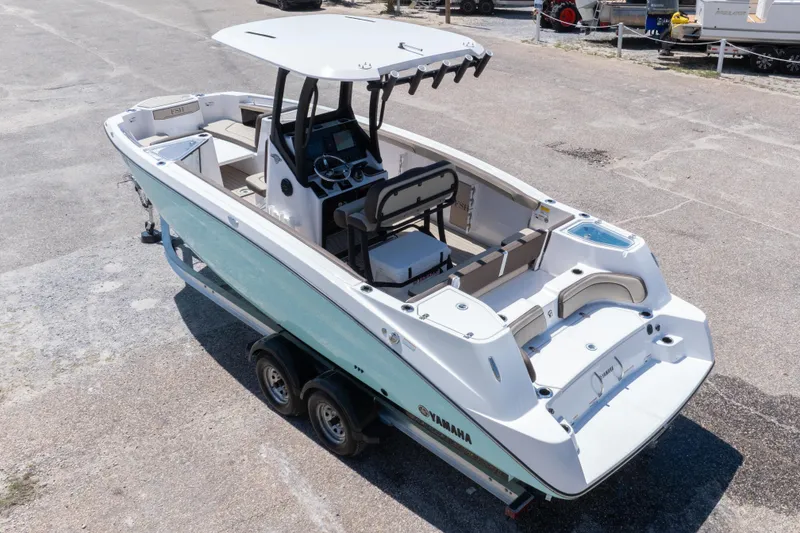 Slide: The Image of 2025 Yamaha Boats 255 FSH Sport E on trailer, showcasing sleek design and spacious interior. - 15