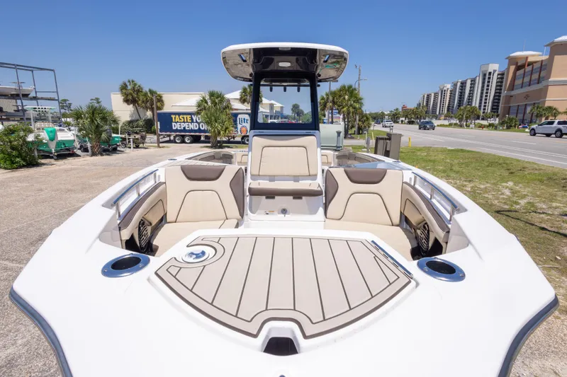 Slide: The Image of 2025 Yamaha Boats 255 FSH Sport E, sleek design, spacious seating, outdoor setting. - 18