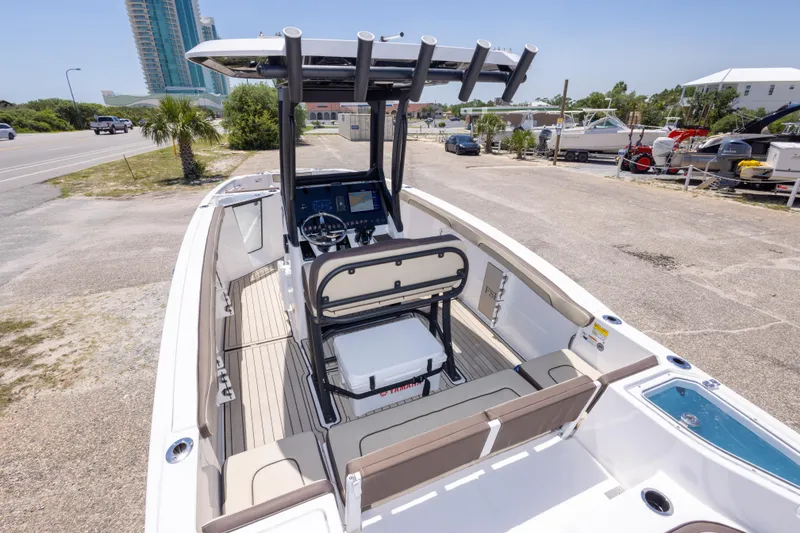 Slide: The Image of 2025 Yamaha Boats 255 FSH Sport E, sleek design, spacious deck, modern controls, coastal setting. - 19