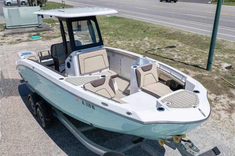 Slide: The Image of 2025 Yamaha Boats 255 FSH Sport E on trailer, showcasing sleek design and spacious seating. - 2