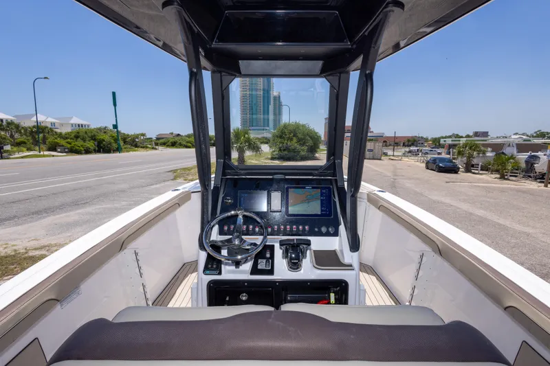 Slide: The Image of 2025 Yamaha Boats 255 FSH Sport E dashboard with navigation display and steering wheel. - 21