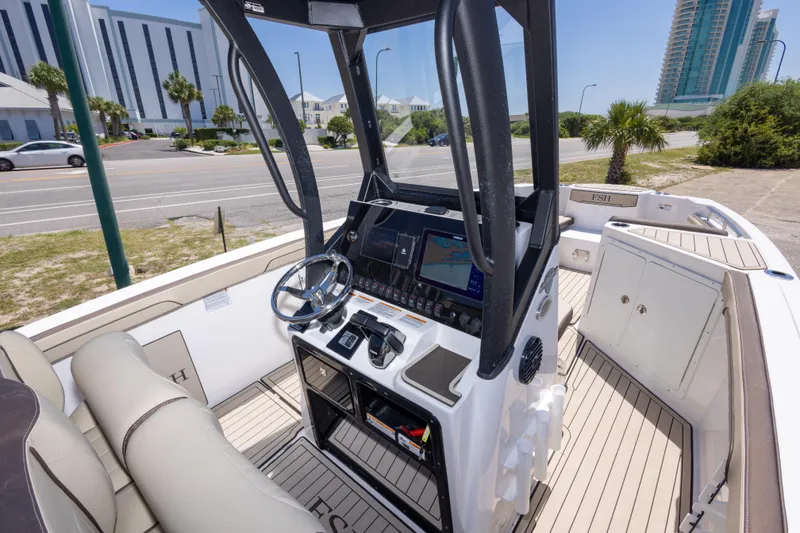 Slide: The Image of 2025 Yamaha Boats 255 FSH Sport E cockpit with modern controls and navigation system. - 22