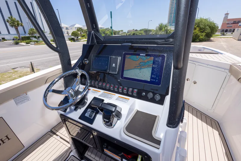 Slide: The Image of Helm of 2025 Yamaha Boats 255 FSH Sport E with navigation display and controls. - 26