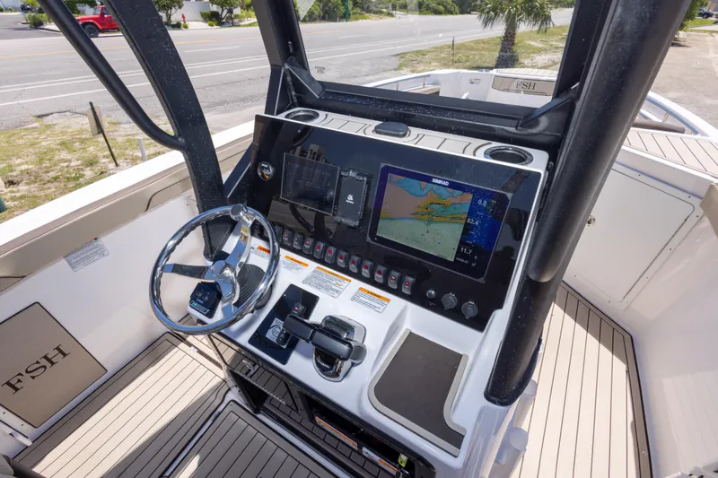 Slide: The Image of 2025 Yamaha Boats 255 FSH Sport E dashboard with navigation display and controls. - 27
