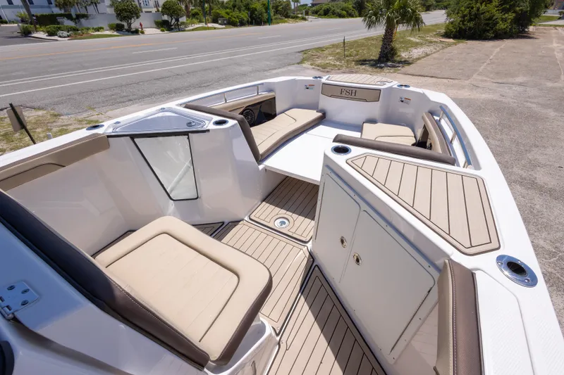 Slide: The Image of 2025 Yamaha Boats 255 FSH Sport E interior with spacious seating and modern design. - 28