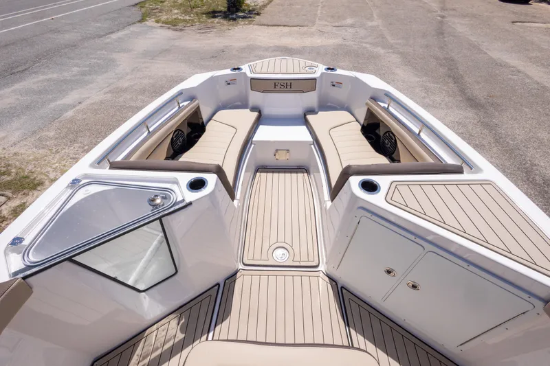 Slide: The Image of 2025 Yamaha Boats 255 FSH Sport E interior with beige seating and sleek design. - 30