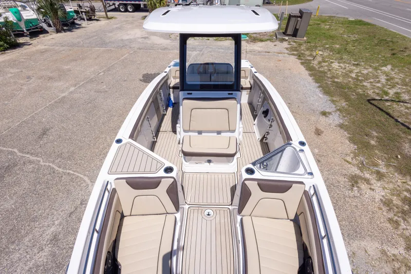 Slide: The Image of 2025 Yamaha Boats 255 FSH Sport E, spacious deck with beige seating and modern design. - 32