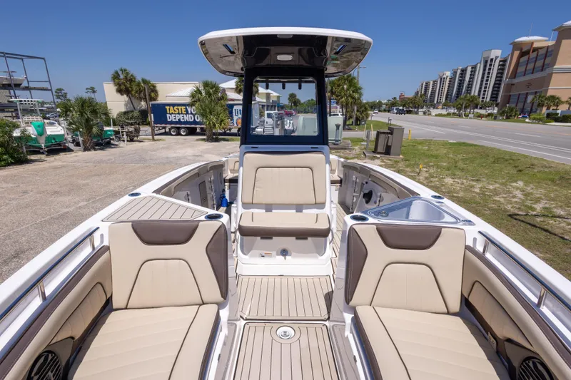 Slide: The Image of 2025 Yamaha Boats 255 FSH Sport E interior with beige seating and modern design. - 33