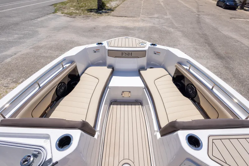 Slide: The Image of 2025 Yamaha Boats 255 FSH Sport E interior with beige seating and cup holders. - 34
