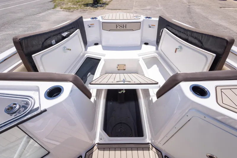 Slide: The Image of 2025 Yamaha Boats 255 FSH Sport E interior with open storage compartments and seating. - 35