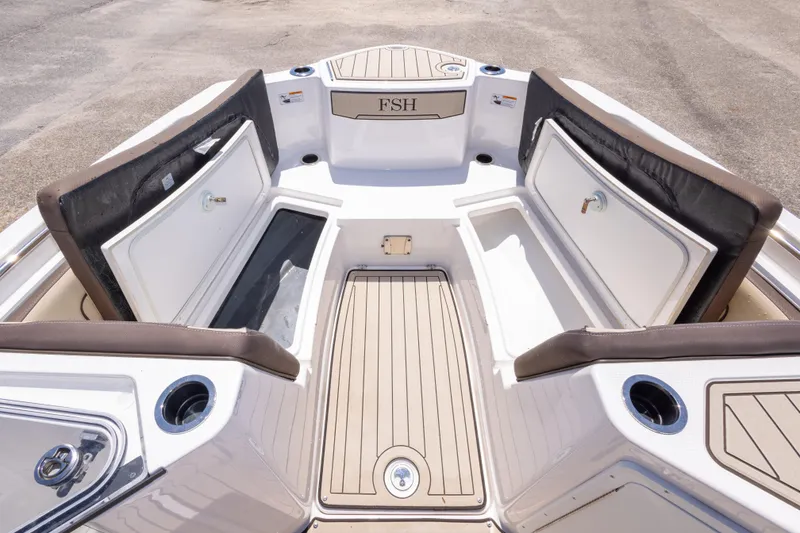 Slide: The Image of 2025 Yamaha Boats 255 FSH Sport E interior with open storage compartments and seating. - 36